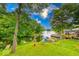 A lush, sloping backyard shows access to the lake and docks at 8635 S Providence Dr, Nineveh, IN 46164