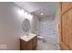 Bright bathroom featuring a vanity with a round mirror and a shower-tub combination at 8635 S Providence Dr, Nineveh, IN 46164