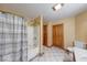 Bathroom with tub and shower combo, mosaic tile border, and wooden doors at 8635 S Providence Dr, Nineveh, IN 46164