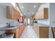 Bright kitchen with natural wood cabinets, gray countertops and stainless steel appliances at 8635 S Providence Dr, Nineveh, IN 46164