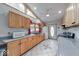 Bright kitchen with natural wood cabinets, gray countertops and stainless steel appliances at 8635 S Providence Dr, Nineveh, IN 46164