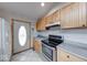 Kitchen featuring stainless steel appliances, tile flooring, wood cabinets, and gray countertop at 8635 S Providence Dr, Nineveh, IN 46164