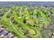 Beautiful aerial view showcasing the community's golf course with lush greens, ponds, and scenic landscaping at 9643 Cypress Way, Carmel, IN 46032