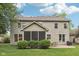 Spacious backyard with a screened porch, patio, mature trees, and lush green lawn, perfect for outdoor living at 9643 Cypress Way, Carmel, IN 46032