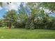 Expansive backyard featuring lush green lawn, mature trees, and beautiful landscaping for outdoor enjoyment at 9643 Cypress Way, Carmel, IN 46032