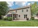 Expansive backyard featuring a screened-in porch, patio area, and well-maintained lawn, great for entertaining at 9643 Cypress Way, Carmel, IN 46032