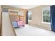 Cozy bedroom featuring a bunk bed with a slide, a climbing wall, and natural light from two windows at 9643 Cypress Way, Carmel, IN 46032
