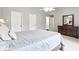 Comfortable bedroom features a dresser, a ceiling fan, and neutral decor at 9643 Cypress Way, Carmel, IN 46032