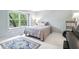 Bright bedroom with large window, neutral decor, and a cozy rug, ideal for relaxation and comfort at 9643 Cypress Way, Carmel, IN 46032