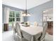 Elegant dining room with large windows, neutral color scheme, and stylish lighting is perfect for Gathering meals at 9643 Cypress Way, Carmel, IN 46032