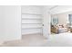 Neutral space features shelves and open doorway to view the adjacent Gathering room at 9643 Cypress Way, Carmel, IN 46032