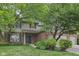 Charming two-story home with brick and vinyl siding, complemented by lush landscaping and a three-car garage at 9643 Cypress Way, Carmel, IN 46032