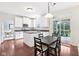 Bright, updated kitchen with island, stainless appliances, white cabinetry, and hardwood floors is ready for cooking at 9643 Cypress Way, Carmel, IN 46032