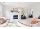 Inviting living room with a cozy fireplace, plush seating, and a warm, neutral color palette is ready to relax at 9643 Cypress Way, Carmel, IN 46032