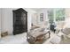 Elegant living room with stylish furniture, a large cabinet, and natural light, creating a sophisticated atmosphere at 9643 Cypress Way, Carmel, IN 46032