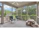 Relaxing screened porch with outdoor seating and views of the lush greenery and fenced-in yard at 9643 Cypress Way, Carmel, IN 46032
