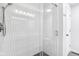 Modern tiled shower features sleek fixtures and a glass door at 9643 Cypress Way, Carmel, IN 46032