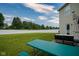 Spacious backyard with a well-maintained lawn, white fence, and an outdoor patio area perfect for entertaining at 9775 Big Bend Dr, Indianapolis, IN 46234