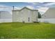 Expansive backyard with a well-maintained lawn, patio furniture, and a white fence at 9775 Big Bend Dr, Indianapolis, IN 46234