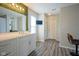 Stylish bathroom with white vanity, unique mirror with lights and leafy trim, and modern fixtures at 9775 Big Bend Dr, Indianapolis, IN 46234