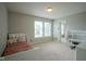 Bright bedroom features natural light, plush carpet, and a cozy teddy bear on the bed at 9775 Big Bend Dr, Indianapolis, IN 46234