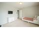 Cozy bedroom with neutral walls, white furniture, and a mounted television at 9775 Big Bend Dr, Indianapolis, IN 46234