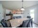 A cozy dining area features a stone-topped dining table set for six, with views into the kitchen at 9775 Big Bend Dr, Indianapolis, IN 46234