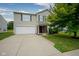 Two-story home features charming curb appeal, a two-car garage, and beautiful landscaping at 9775 Big Bend Dr, Indianapolis, IN 46234