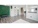 Stylish foyer highlighting an accent wall, modern shelving, and open staircase at 9775 Big Bend Dr, Indianapolis, IN 46234