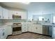 Well-lit kitchen with stainless steel appliances, white cabinets, and stylish countertops at 9775 Big Bend Dr, Indianapolis, IN 46234