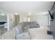 Bright living room featuring a comfortable sectional sofa, neutral carpet, and a wall-mounted television at 9775 Big Bend Dr, Indianapolis, IN 46234