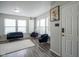 A welcoming living room features modern decor, natural light from multiple windows, and stylish seating arrangement at 9775 Big Bend Dr, Indianapolis, IN 46234