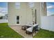 Cozy outdoor patio features a comfortable seating area with an umbrella and a convenient access door to the home at 9775 Big Bend Dr, Indianapolis, IN 46234