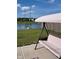 Backyard view from patio, includes a comfortable cushioned swing, pond view and fence at 10218 Arctic Edge Dr, Indianapolis, IN 46259