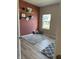 Bedroom with a gray area rug, window, and a decorative display of graduation caps and awards on the wall at 10218 Arctic Edge Dr, Indianapolis, IN 46259