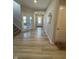 Entryway featuring wood-look floors, natural light, glass panelled french doors, and staircase at 10218 Arctic Edge Dr, Indianapolis, IN 46259
