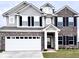 Charming two-story home featuring a brick and vinyl facade with a well-manicured lawn and attached two-car garage at 10218 Arctic Edge Dr, Indianapolis, IN 46259