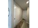 Hallway view of closet doors and wood-look flooring at 10218 Arctic Edge Dr, Indianapolis, IN 46259