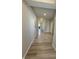 Long hallway with wood-look flooring, neutral paint, and views to the dining room at 10218 Arctic Edge Dr, Indianapolis, IN 46259