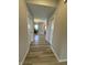Hallway showcases clean neutral paint and wood-look floors leading into an adjacent dining room at 10218 Arctic Edge Dr, Indianapolis, IN 46259