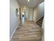 Hallway with wood-look flooring leading to the stairs and dining room at 10218 Arctic Edge Dr, Indianapolis, IN 46259