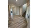 Hallway featuring wood floors leading past staircase with natural light, and into open dining area at 10218 Arctic Edge Dr, Indianapolis, IN 46259