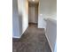 Hallway featuring neutral paint, plush carpet, modern doors, and stylish railings at 10218 Arctic Edge Dr, Indianapolis, IN 46259