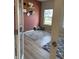 Home office with a light grey rug and a window letting in natural light, plus a salmon accent wall at 10218 Arctic Edge Dr, Indianapolis, IN 46259