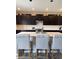 Kitchen featuring island with bar stool seating, a gas range, stainless steel appliances, and dark cabinetry at 10218 Arctic Edge Dr, Indianapolis, IN 46259