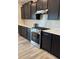 Kitchen with a gas range, stainless steel appliances, white subway tile backsplash, and dark cabinetry at 10218 Arctic Edge Dr, Indianapolis, IN 46259