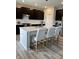 Bright kitchen island, seating, and modern stainless appliances create a functional and stylish space for meal preparation at 10218 Arctic Edge Dr, Indianapolis, IN 46259