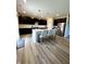 Modern kitchen features dark cabinets, quartz counters, stainless appliances, island with chairs, and wood grain flooring at 10218 Arctic Edge Dr, Indianapolis, IN 46259