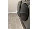 Laundry room featuring modern appliances and grey tile floors at 10218 Arctic Edge Dr, Indianapolis, IN 46259