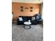 Cozy living room features a modern couch, round table, and a stylish orange accent wall with art at 10218 Arctic Edge Dr, Indianapolis, IN 46259